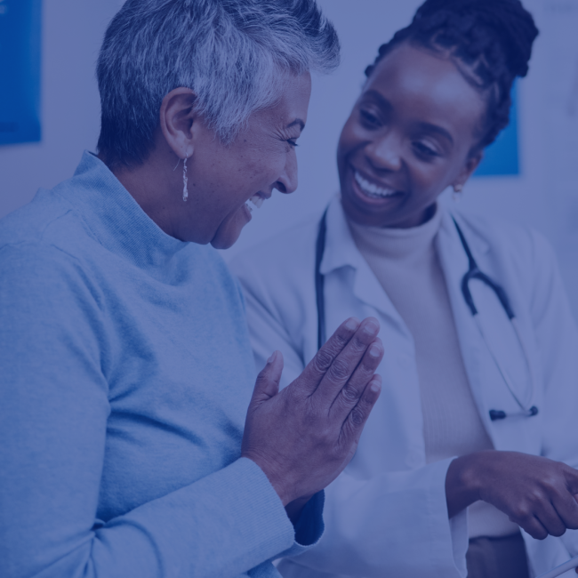 A patient and doctor look happy as they go over the patient's health results.