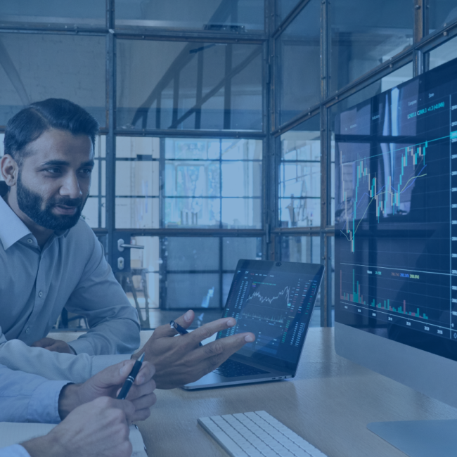 A colleague review data on a desktop computer. 