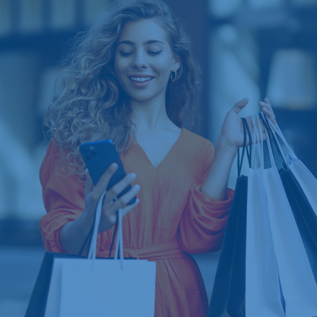 Woman with shopping bags looking at her phone