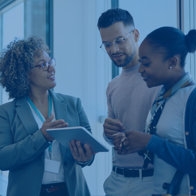 A couple consult a bank teller. 