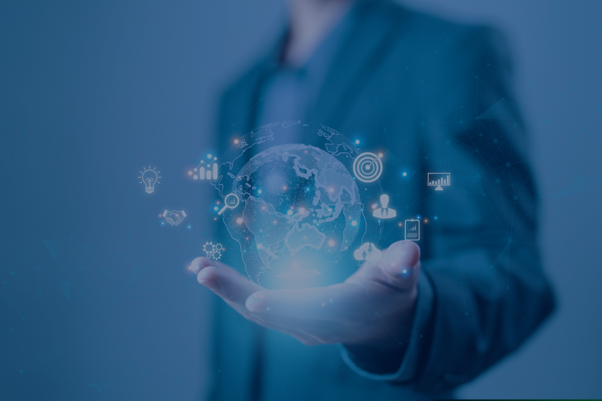 A man in a suit holds a holographic globe with various icons orbiting it.