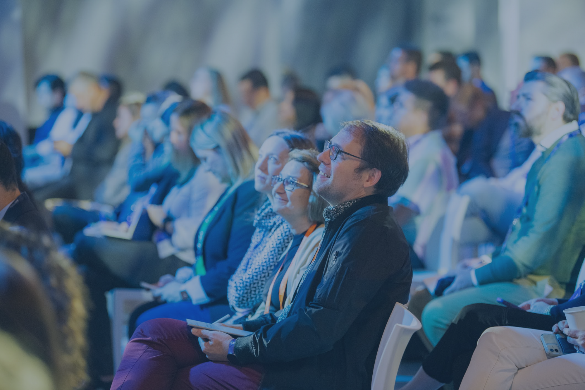 Engaged audience members looking at the stage.