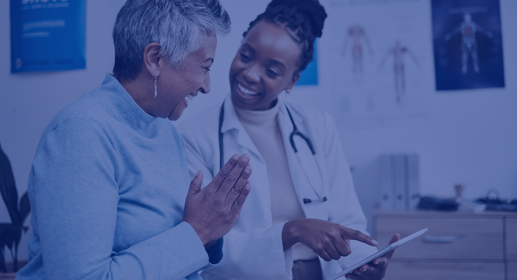 A patient and doctor look happy as they go over the patient's health results.