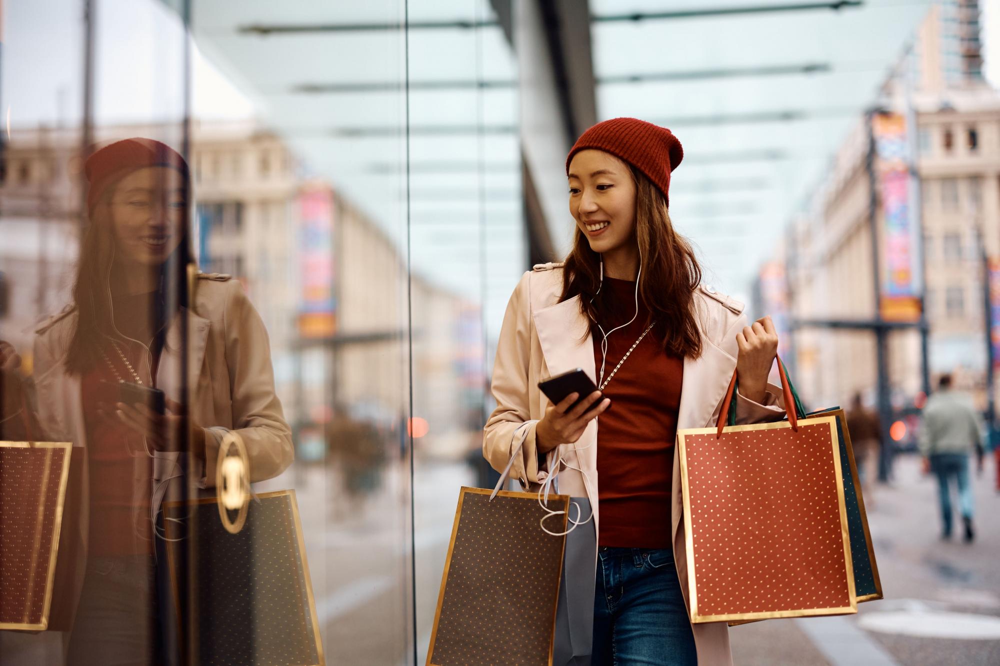 Woman shopping with a phone in her hand.
