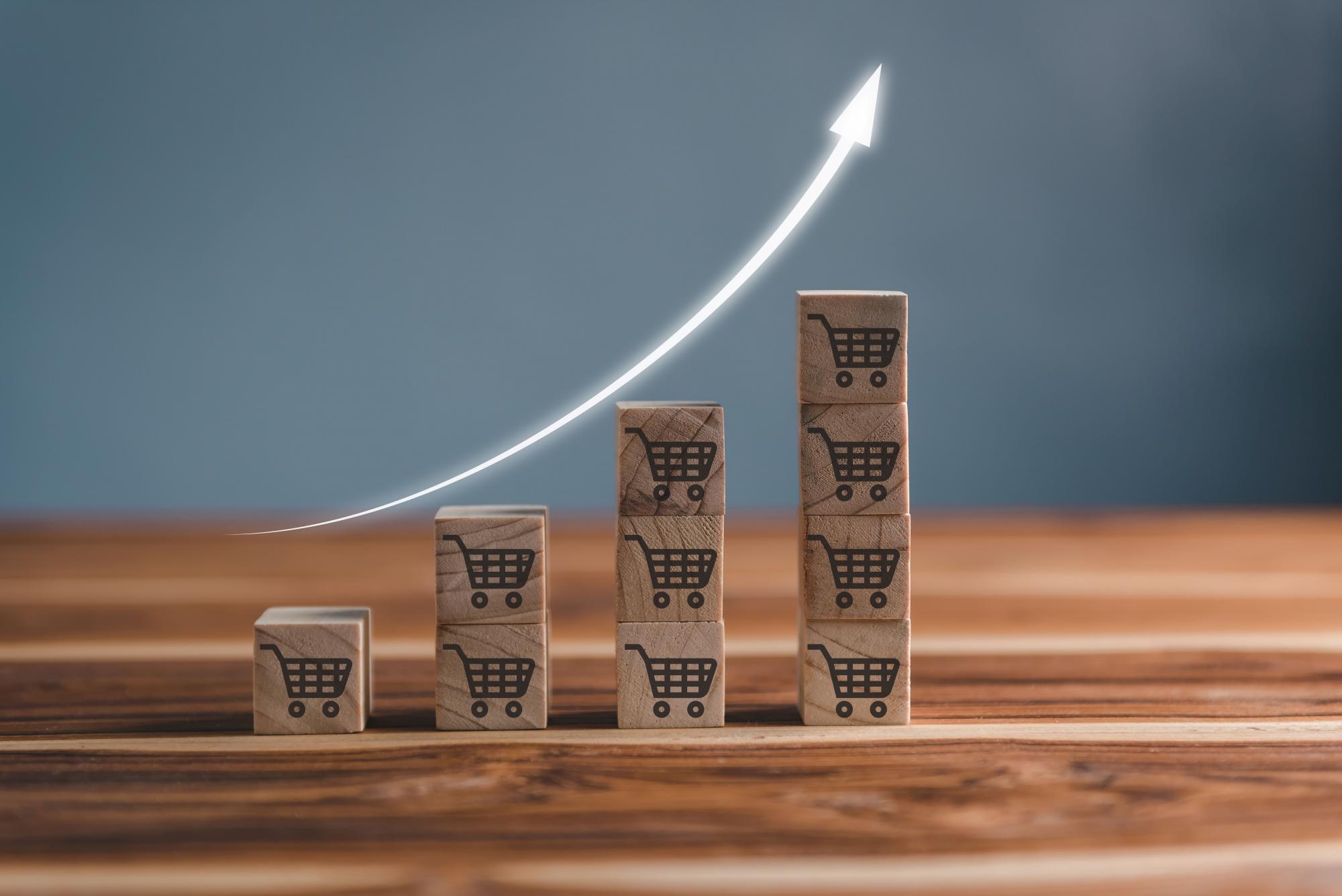 Blocks with shopping carts in an increasing bar graph formation.