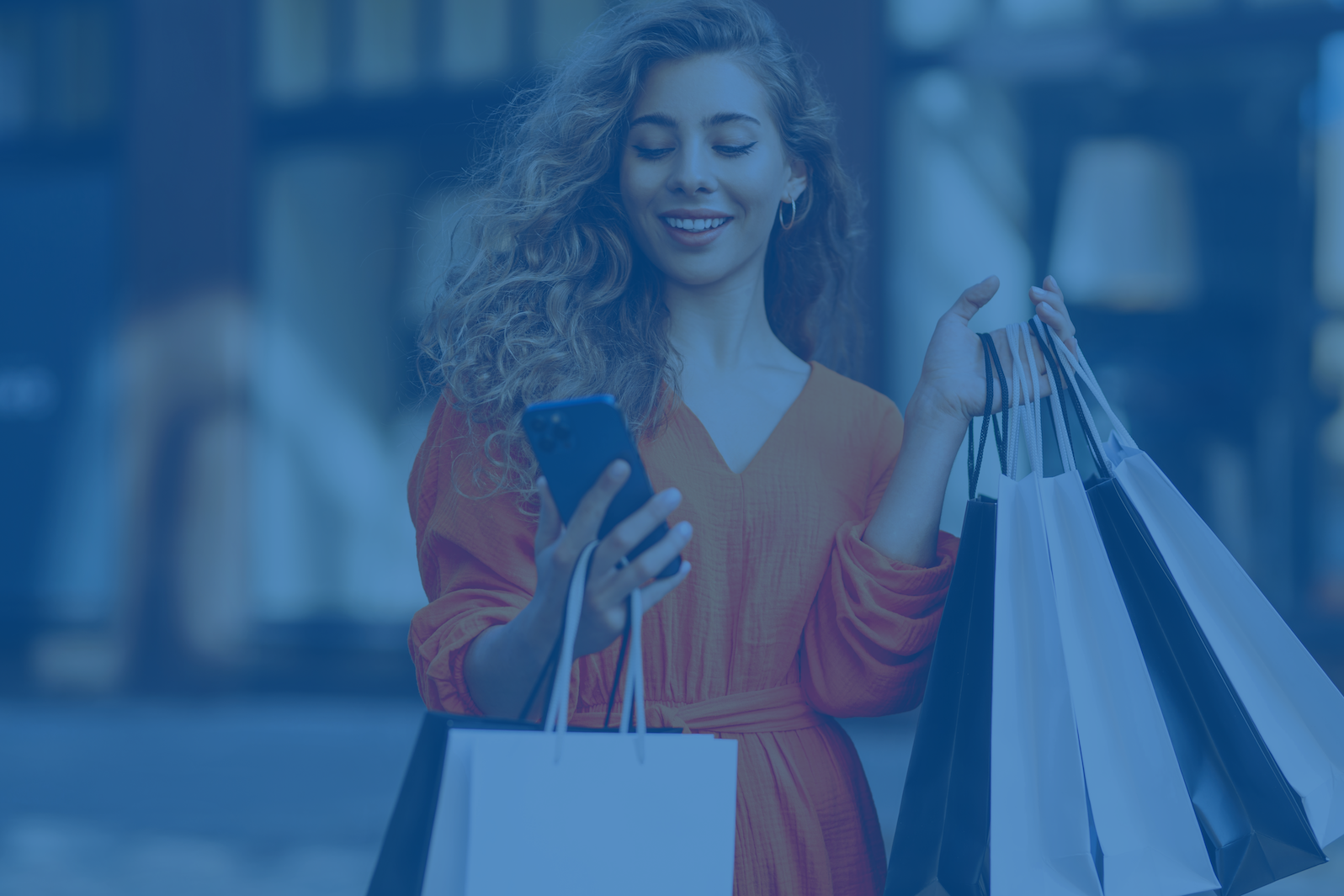 Woman with shopping bags looking at her phone